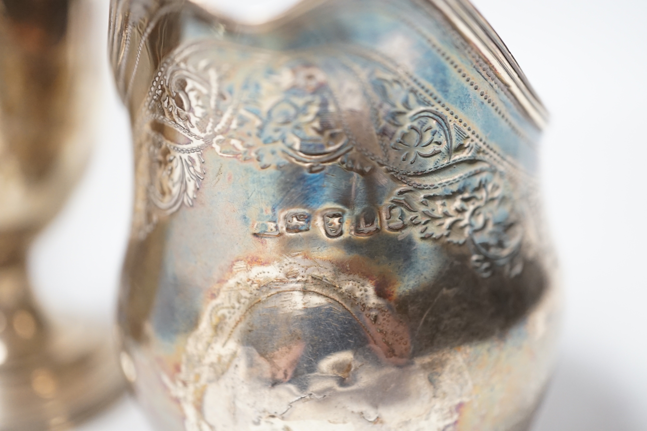 A George III silver cream jug, London, 1806, a George III silver half pint baluster mug, London, 1769 and a later silver two handled trophy cup, 13.7oz.